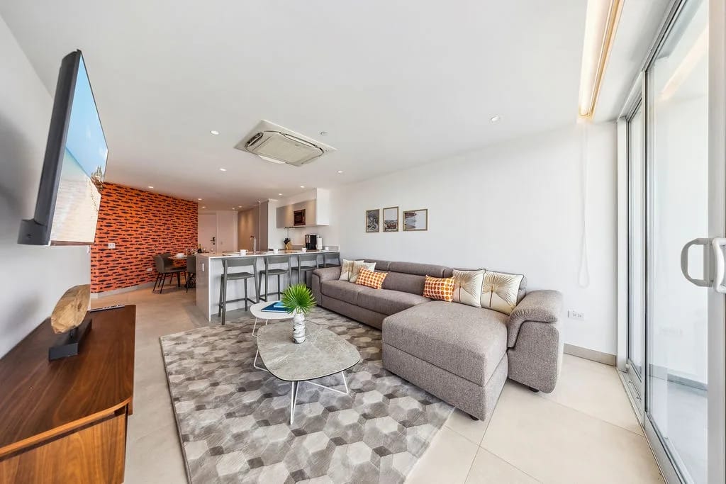 Step into your bright, open living space where modern comfort meets vibrant design. Relax on the plush sectional, enjoy your favorite shows, and feel at home in this thoughtfully designed retreat.