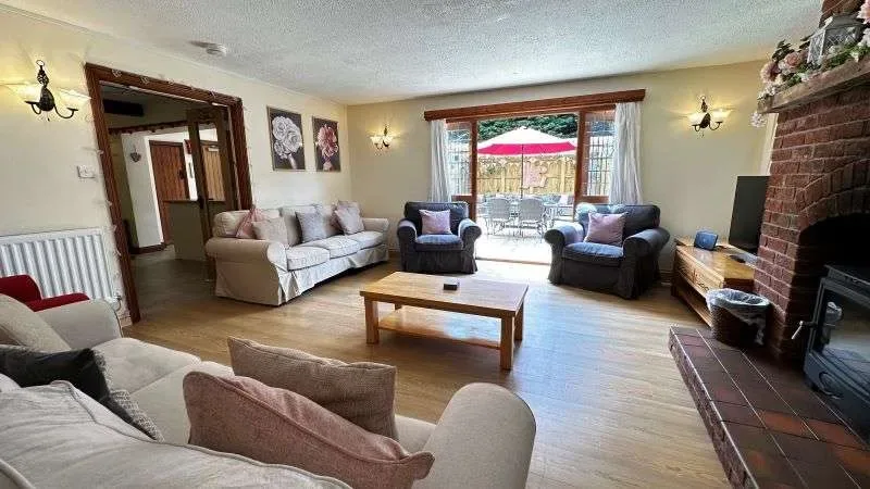 Lounge with seating and doors opening to patio Area at Bury Hill Farm Holiday Cottage