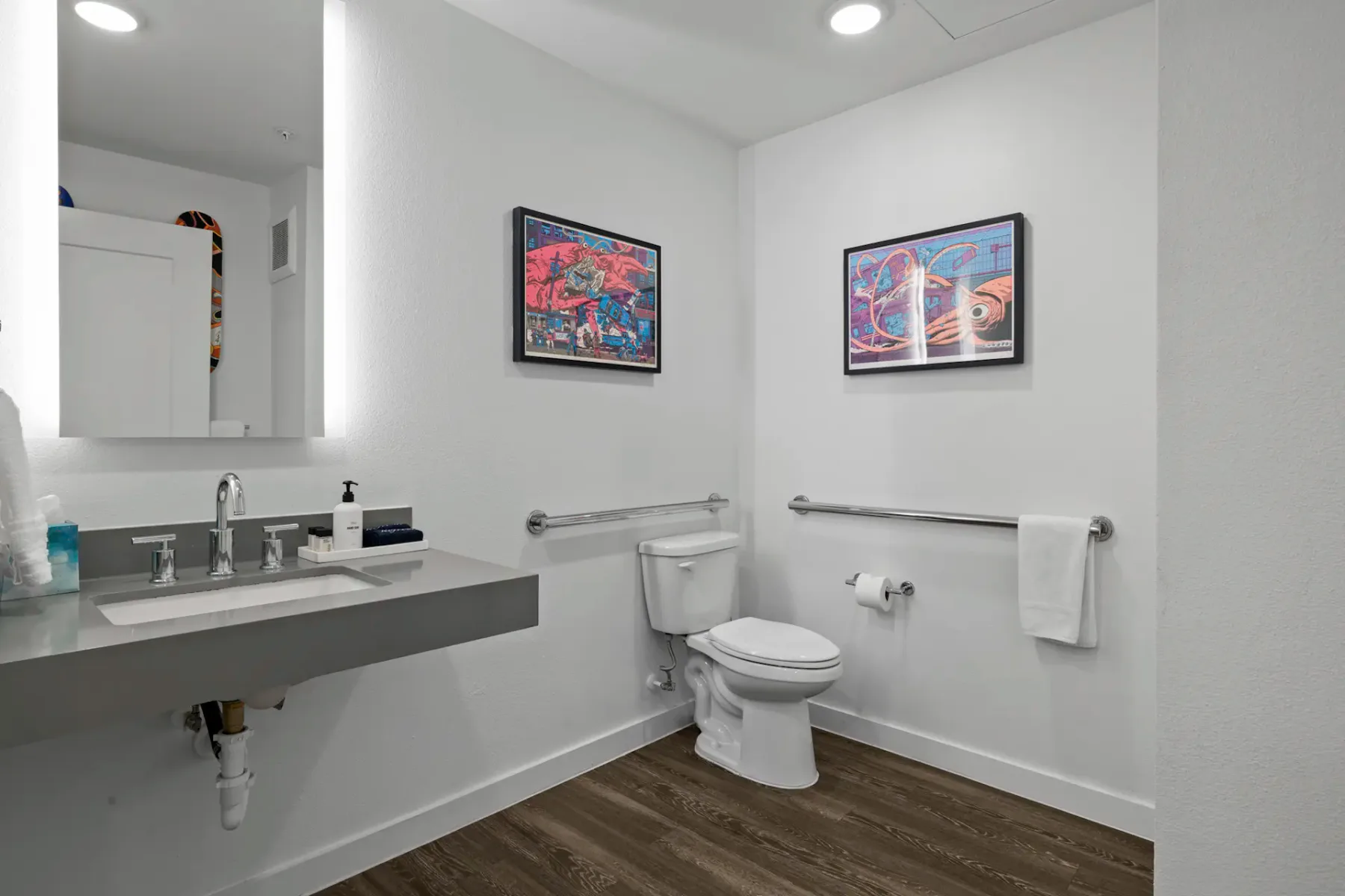 Bathroom with a modern sink, toilet and towel rail.