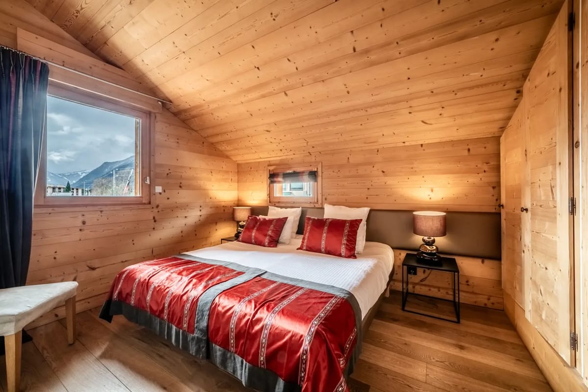 A bed in a wooden room.