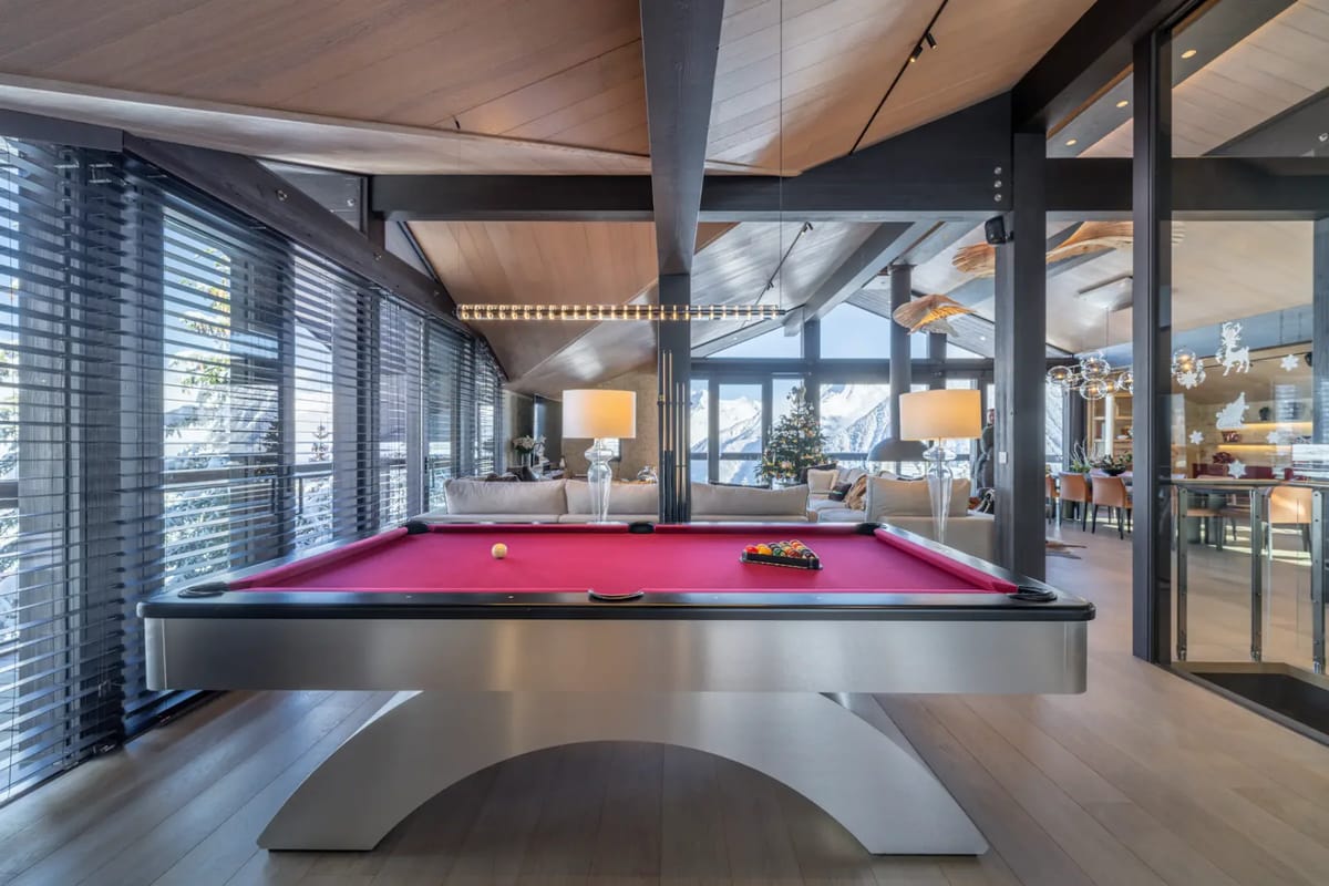 Interior room with a red pool table and seating area.
