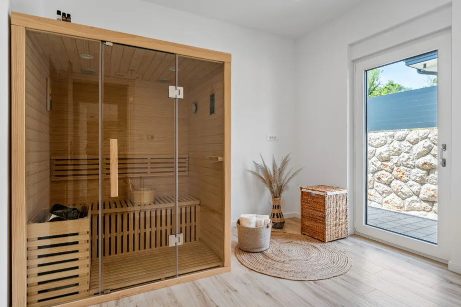 Finnish sauna with access toward the outdoors and pool area