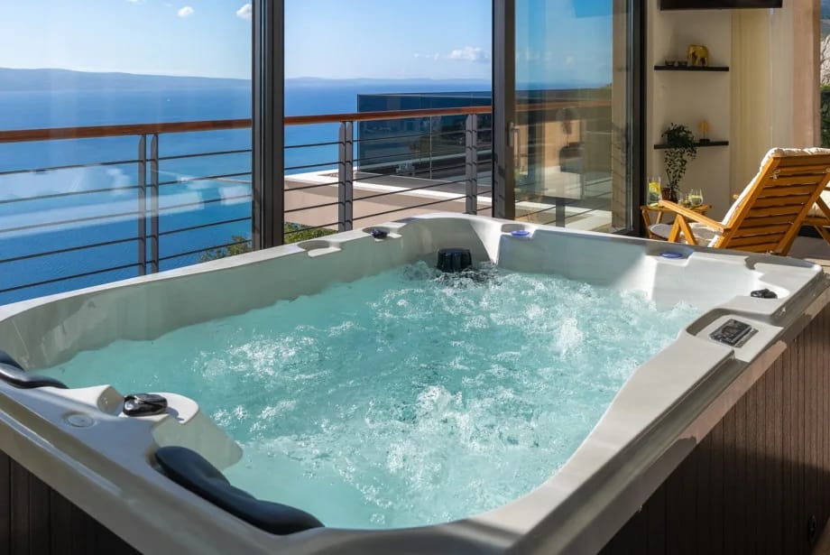 Rooftop wellness area with infrared sauna, whirlpool, shower and TV.