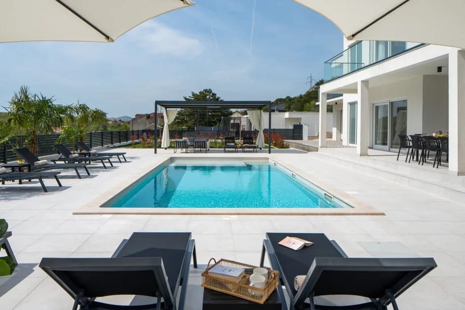 A large private pool with loungers
