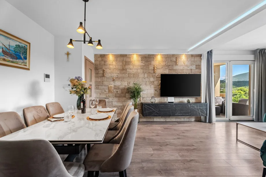 Spacious dining and living area with a pool view