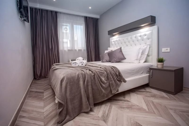 Dormitorio 1 con cama queen size, baño privado, TV y aire acondicionado