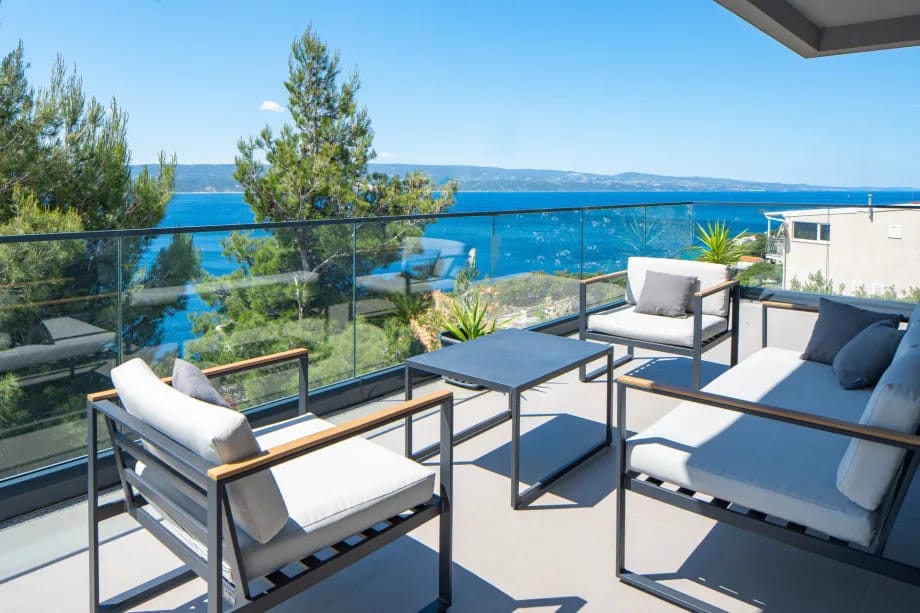 Covered lounge corner with sea views and access from the living room
