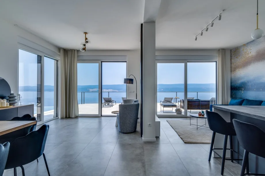 Ground-floor living area with television, air conditioning, Wi-Fi, and doors to the pool area