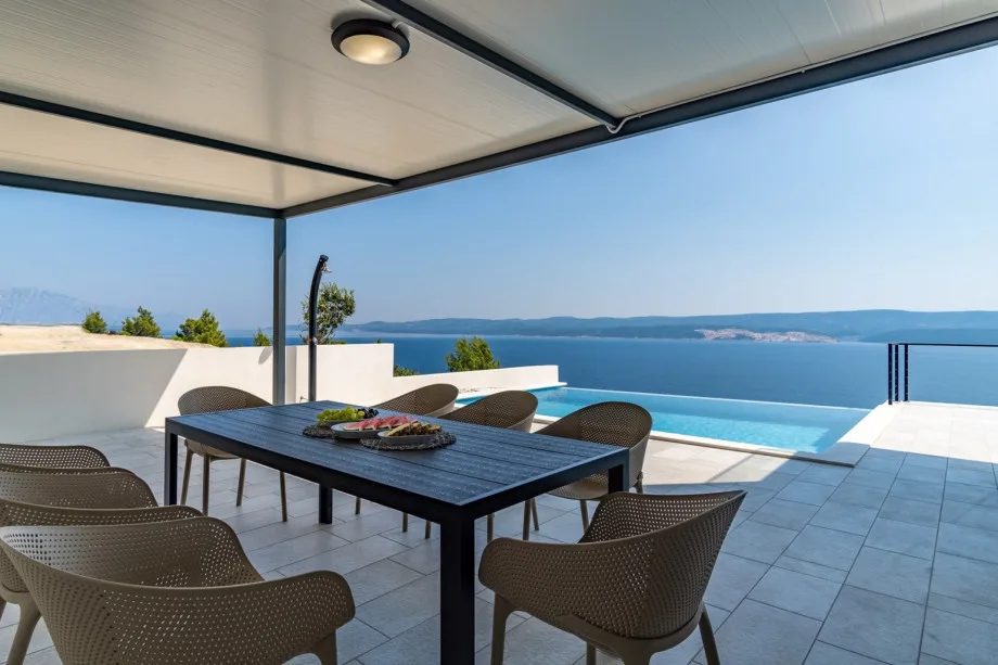 Covered outdoor dining area with barbecue