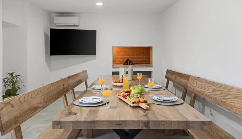 Summer kitchen with dining area, barbecue, air conditioning, and TV