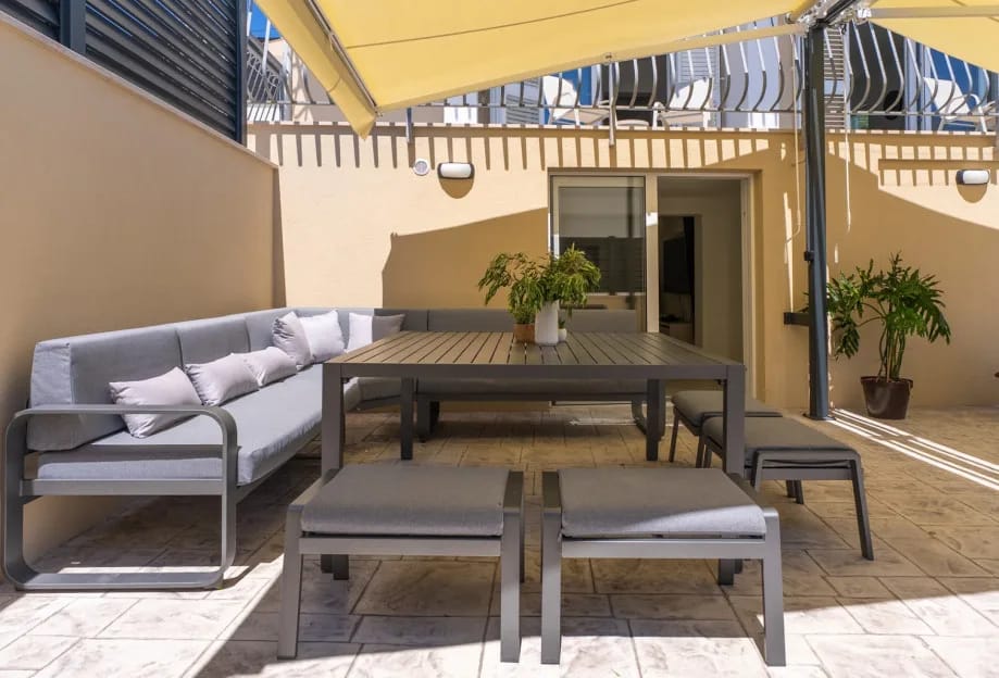 Outdoor area with deck chairs around the pool and a lounge area