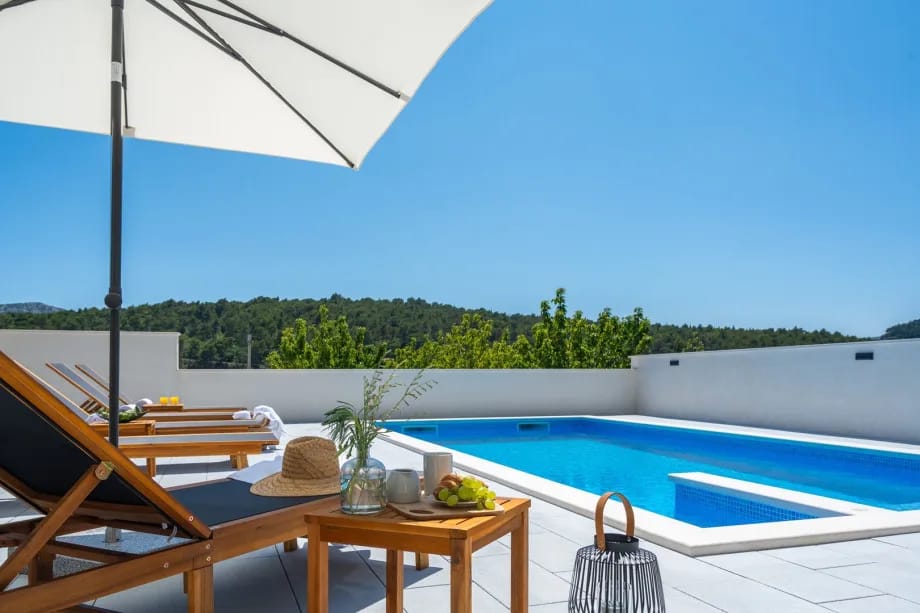 A private, heated 32 sqm swimming pool, 6 deck chairs and outdoor shower
