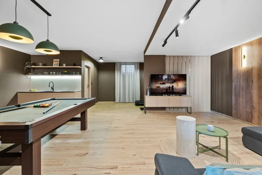 The 55sqm media room with a pool table and entertainment area.
