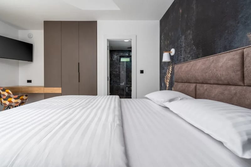 El dormitorio n.º 1 está separado, pero también en la planta baja, y cuenta con una cama tamaño queen de 160 x 200 cm, aire acondicionado, TV y baño privado con ducha