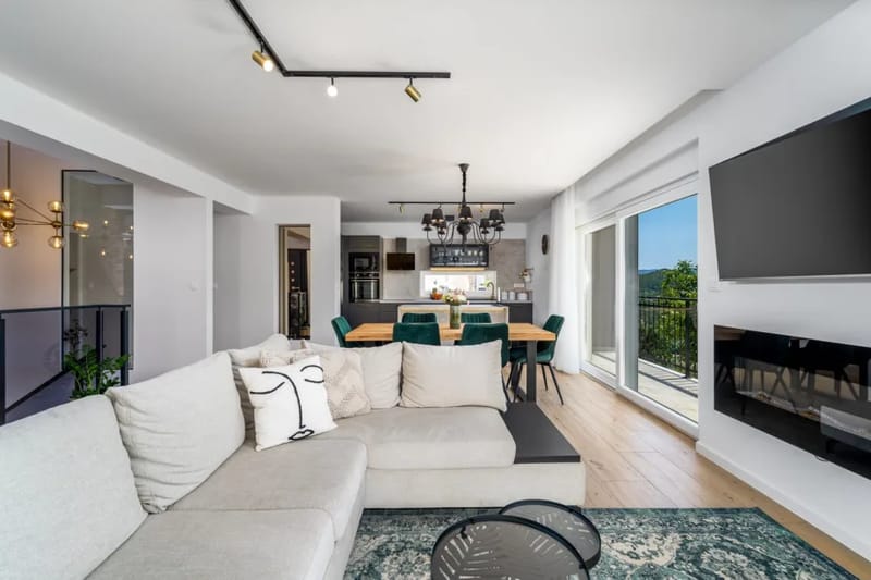 Living room with a flat-screen TV and views toward the pool area