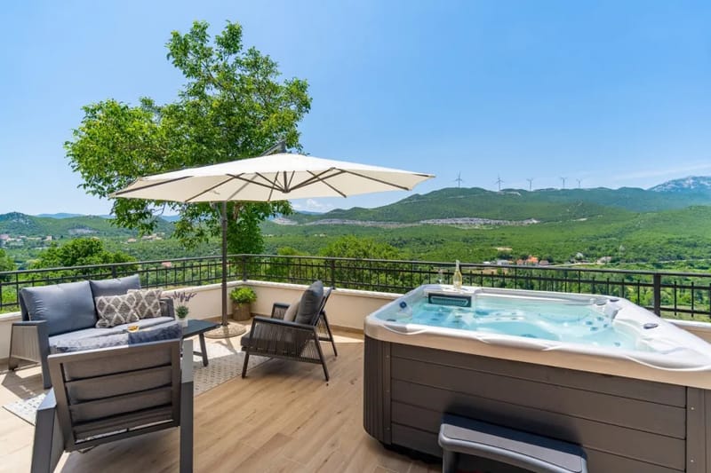 Terrace with a Jacuzzi and outdoor lounge corner