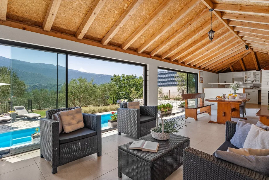 Fully equipped summer kitchen with barbecue and covered area for dining and sitting
