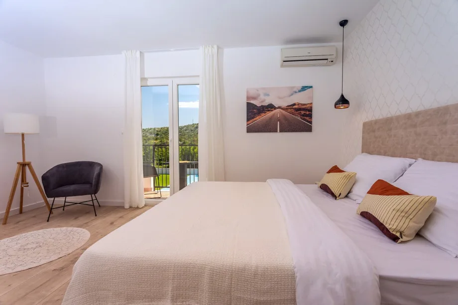 Bedroom 1 with king-size bed, en-suite shower bathroom and air conditioning