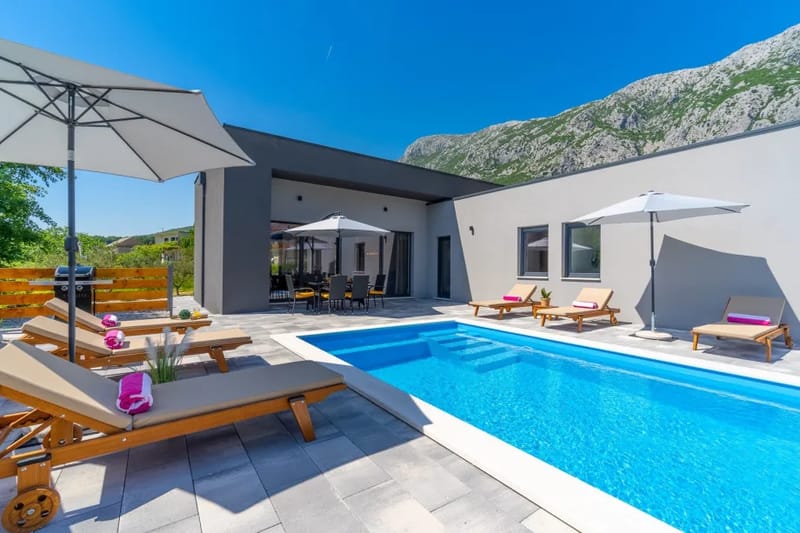 Private swimming pool with 6 deck chairs, outdoor dining area with BBQ