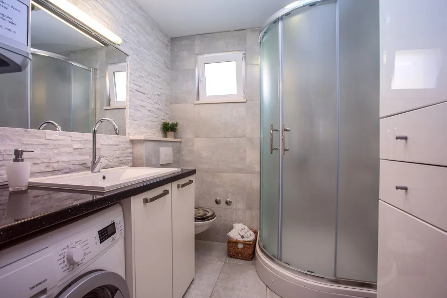 Bathroom with shower and washing machine