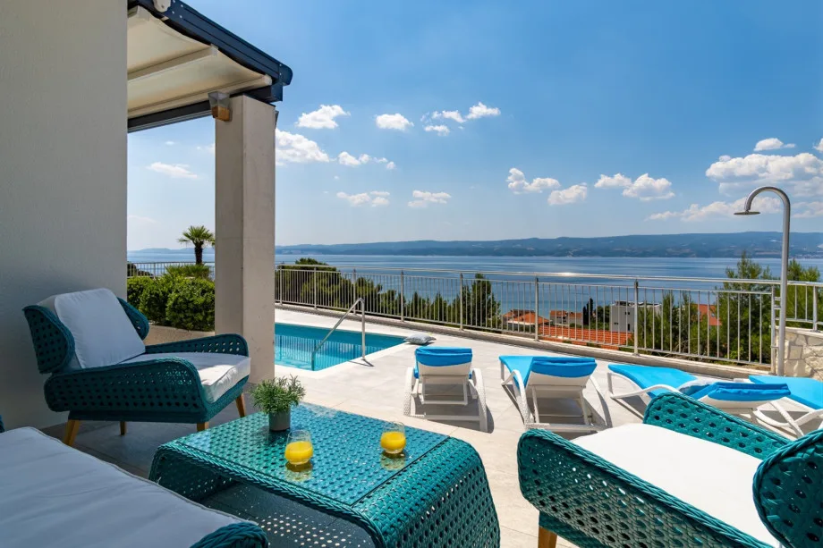 Sun deck area with 6 deck chairs, outdoor shower, and lounge area