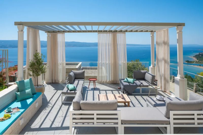 A cozy lounge area with curtains and sea views