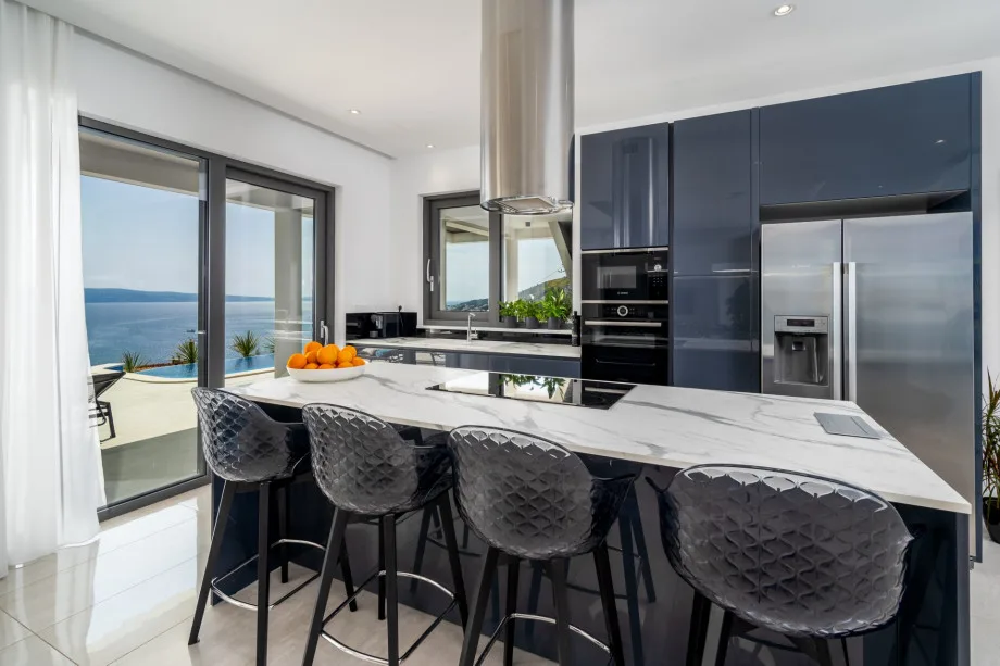 Modern fully equipped kitchen with access to the pool area