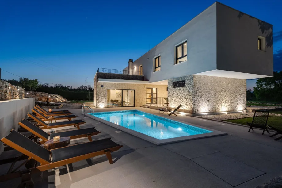 Piscina privada climatizada y zona para tomar el sol con seis tumbonas