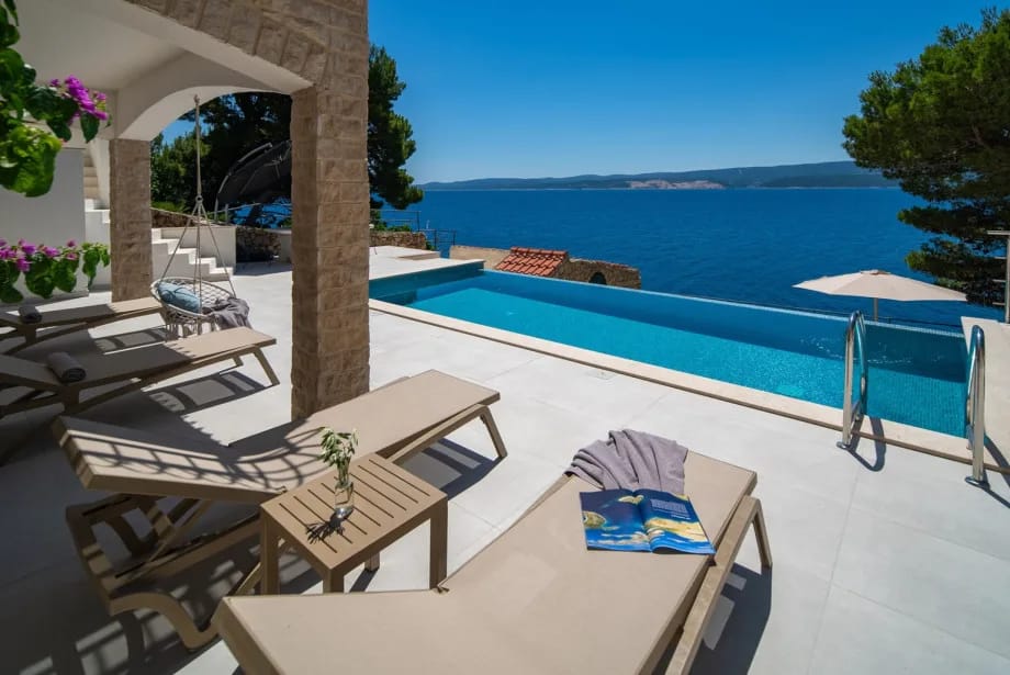 Main sun deck surrounding the pool with eight deck chairs.