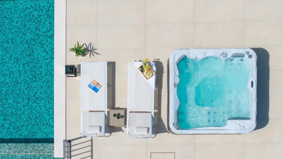 Covered outdoor dining area with television and whirlpool