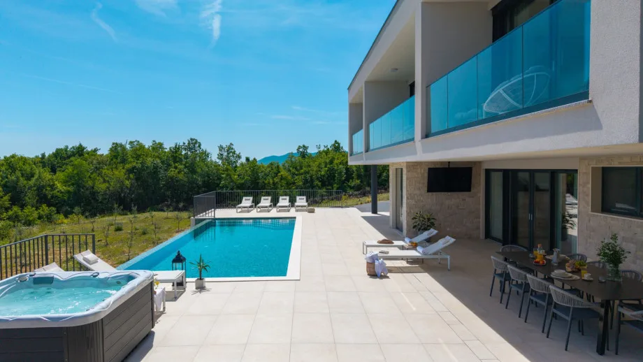 Private heated swimming pool and sun deck with eight deck chairs