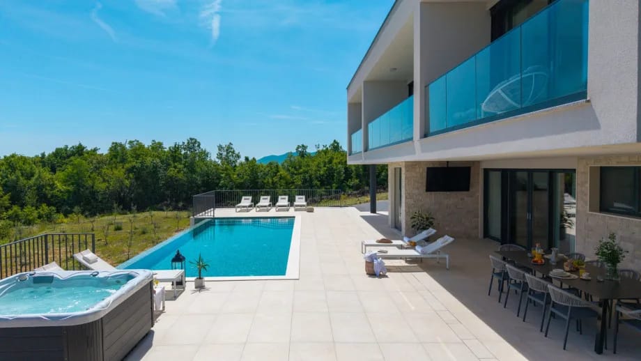 Private heated swimming pool and sun deck with eight deck chairs