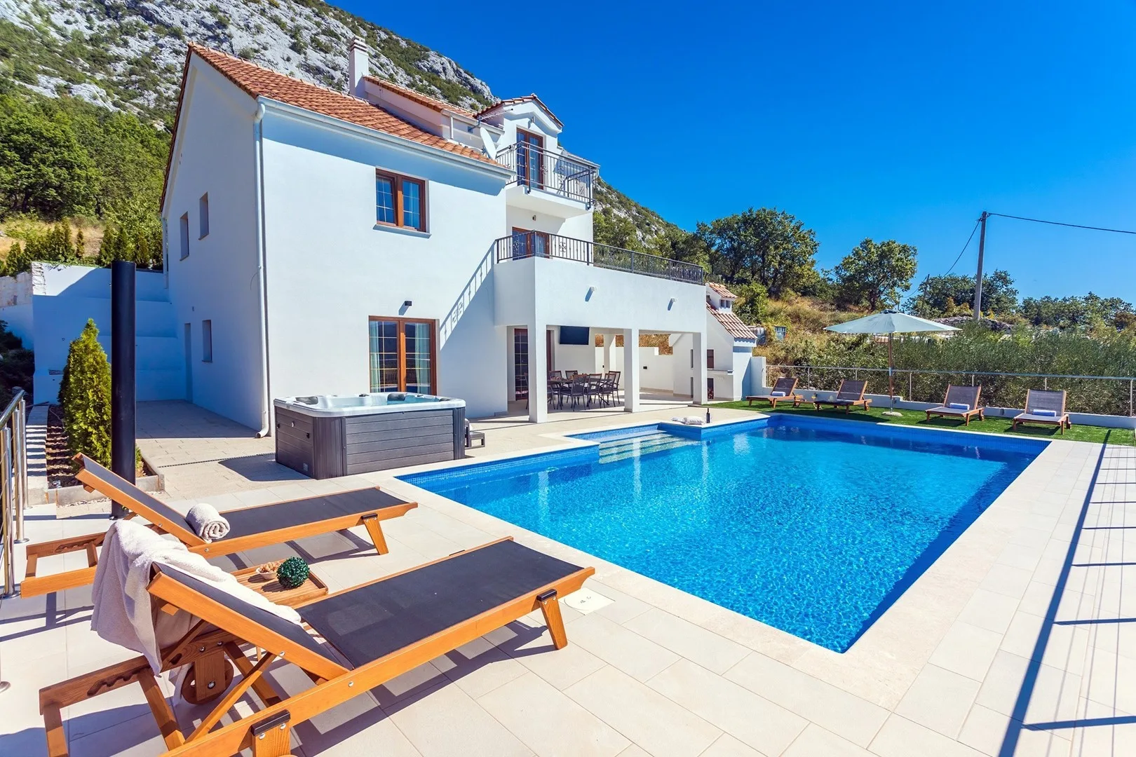 Private swimming pool, Jacuzzi, covered outdoor dining area, deck chairs, umbrellas, TV, darts and barbecue