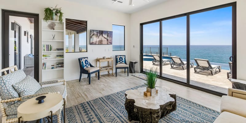 Espacio abierto de sala, comedor y cocina con vistas al mar