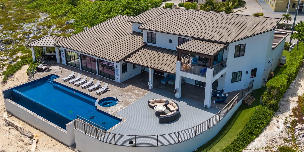 Aerial view of the villa, pool, and spa
