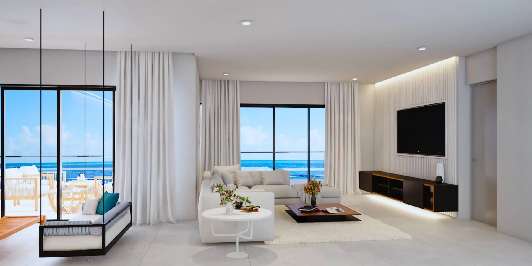 Una luminosa sala de estar da a un balcón con vistas al mar.