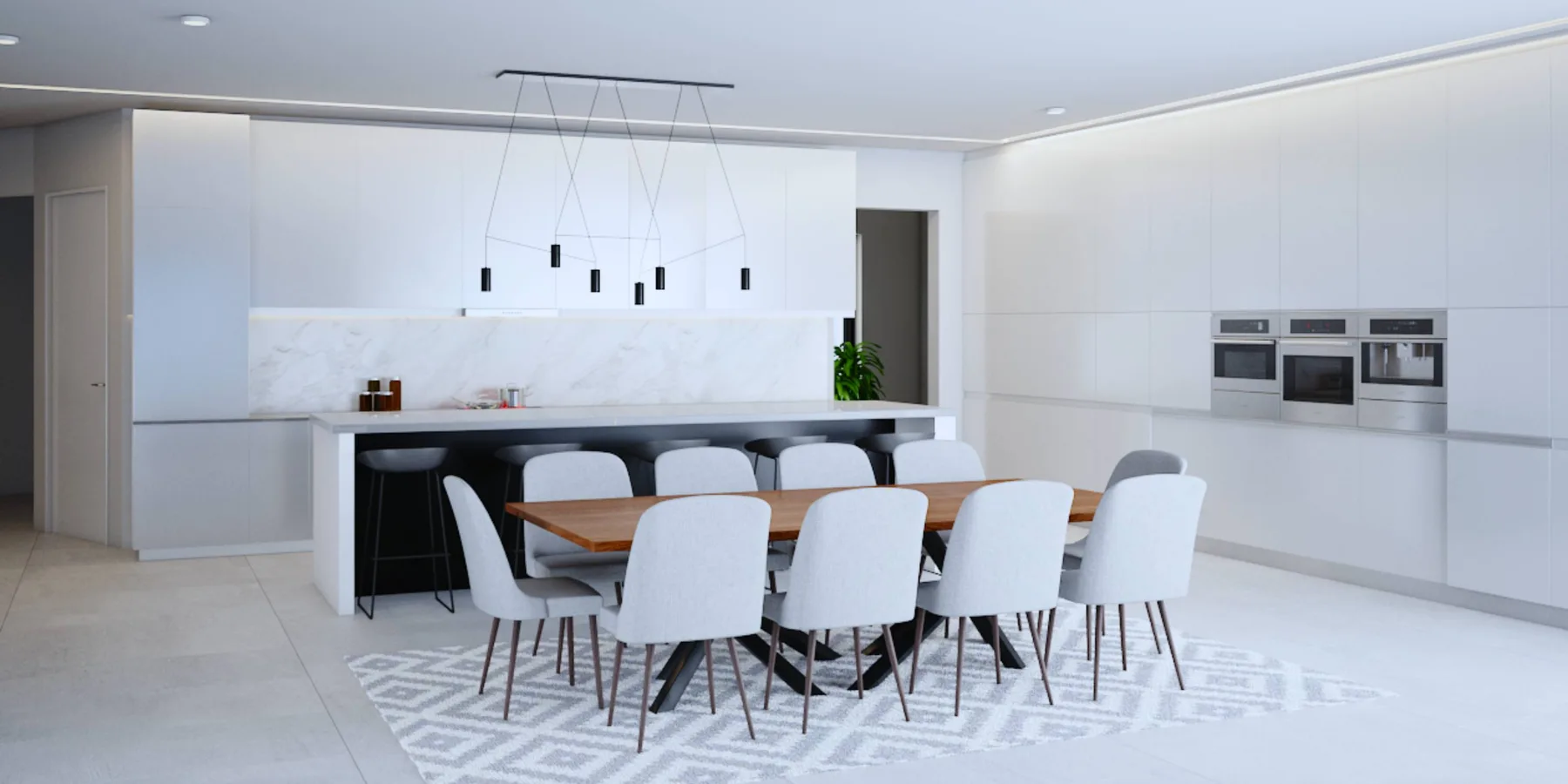 A modern kitchen and dining area with a long table and white seating.