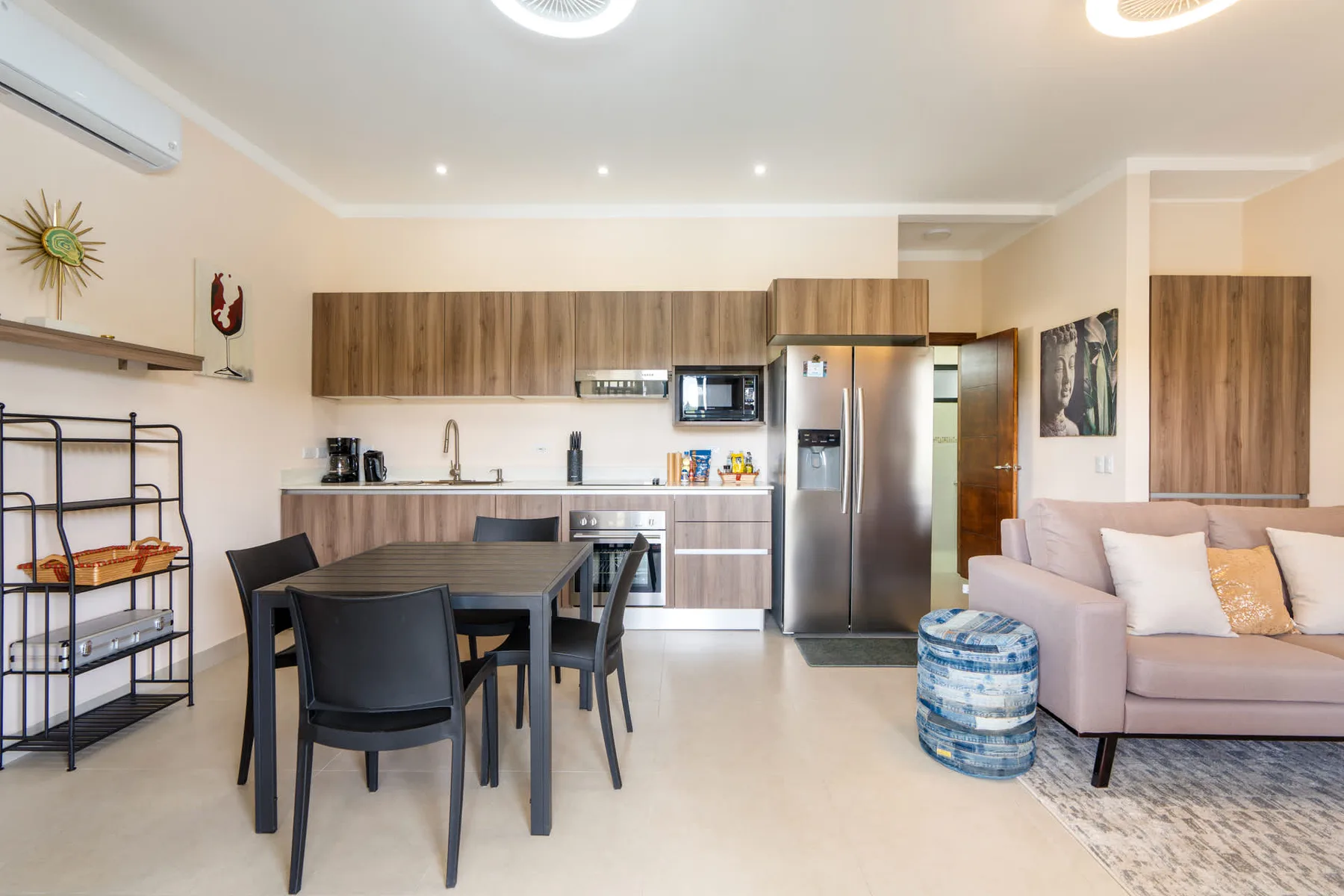 An open-plan kitchen and dining area with a table and seating beside the kitchen.