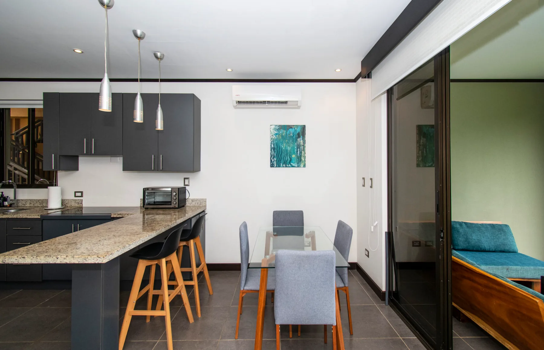 An open-plan kitchen and dining area with a countertop and table seating.