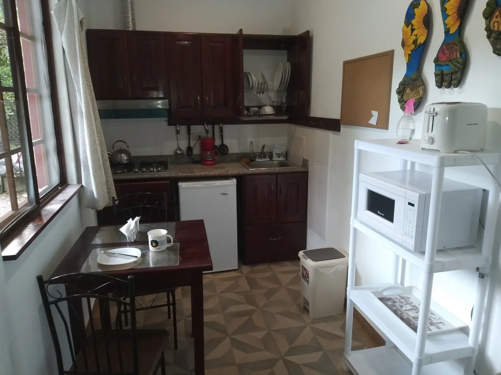 Kitchen with dining table, refrigerator and microwave