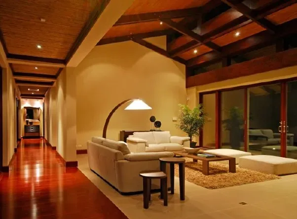 A spacious living room with seating, a coffee table, and a hallway.