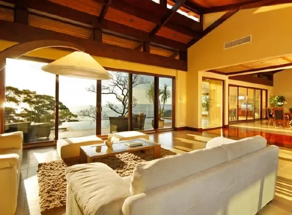 A spacious living room with seating, a low table, and large glass doors.
