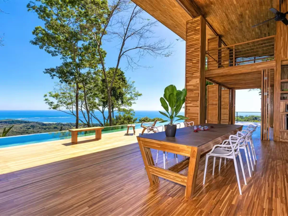 An open-air wooden dining area overlooks the ocean.