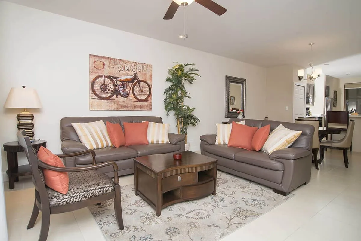 A living room with two sofas, an armchair, and a coffee table.
