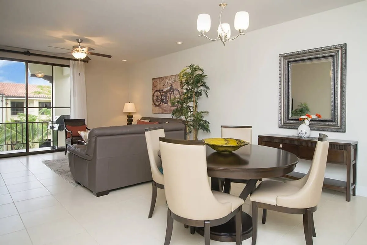 A living and dining area with a round table and seating beside glass doors.