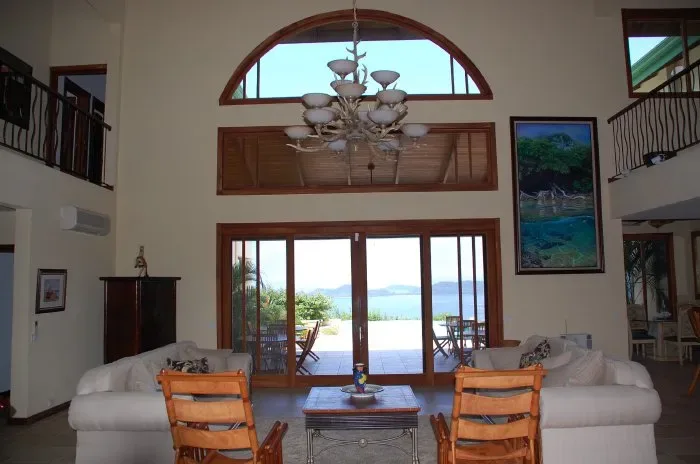 A spacious living room opens onto a patio through wide glass doors.