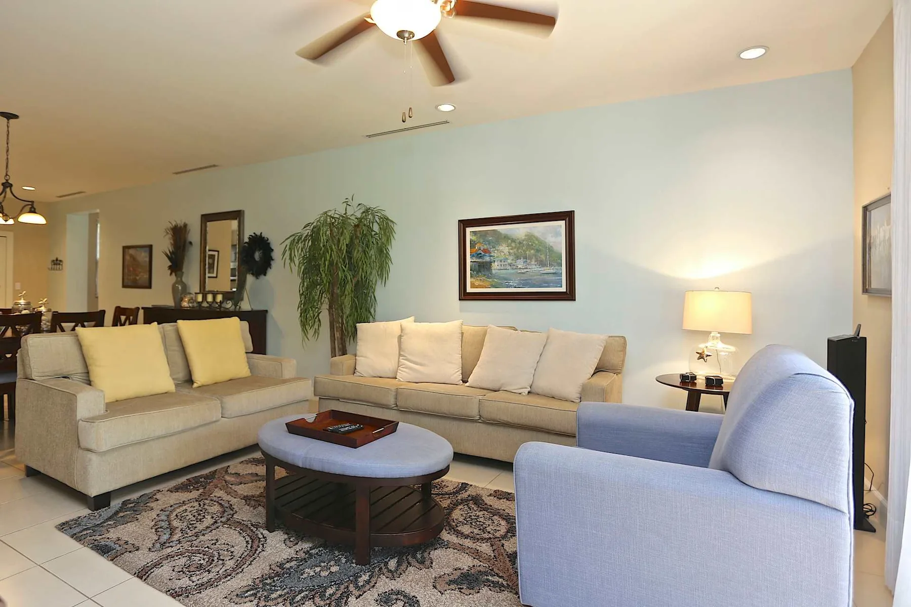 A living room with seating around a coffee table on a patterned rug.