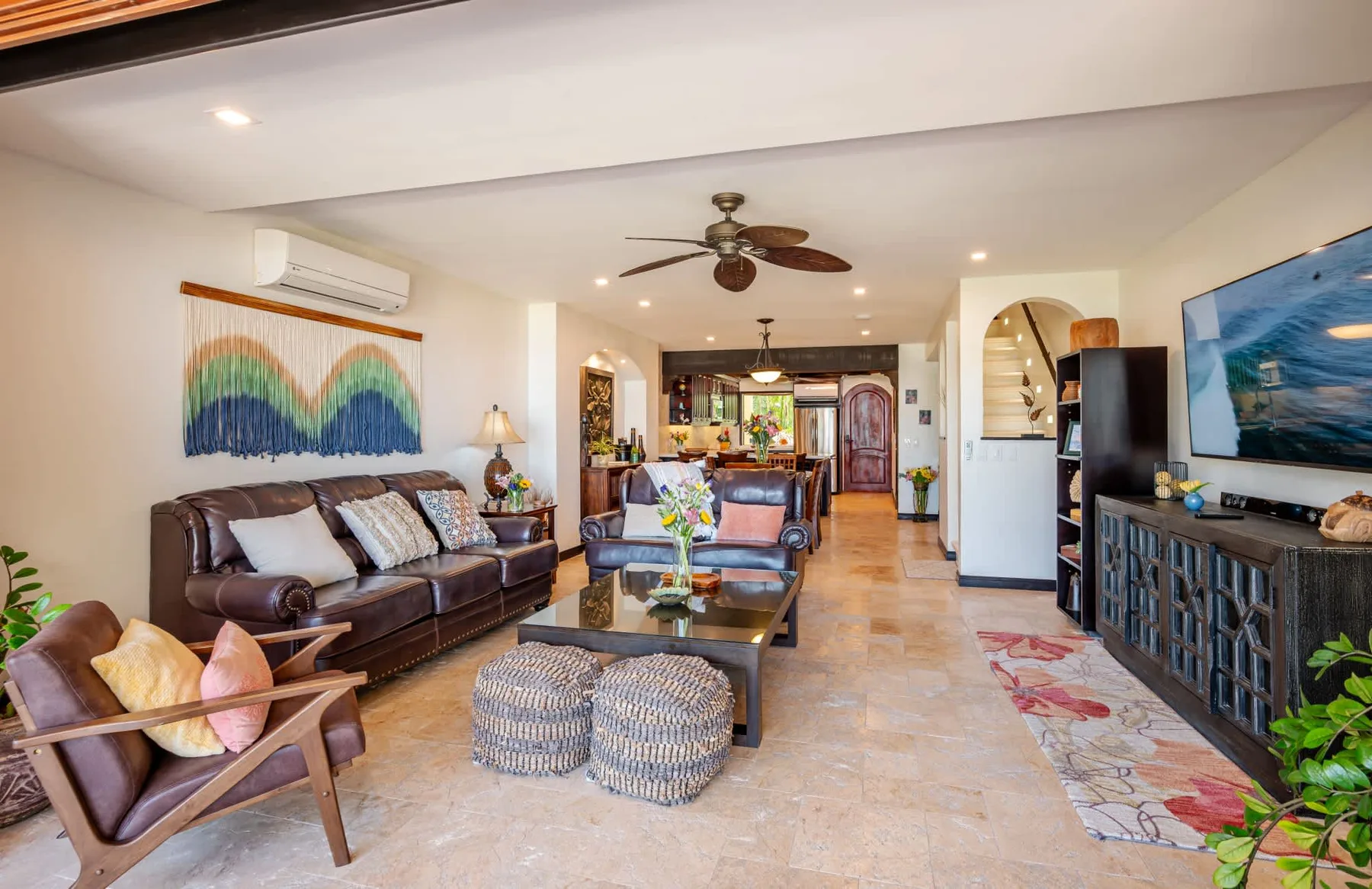 A living room with seating, a television, and a coffee table.