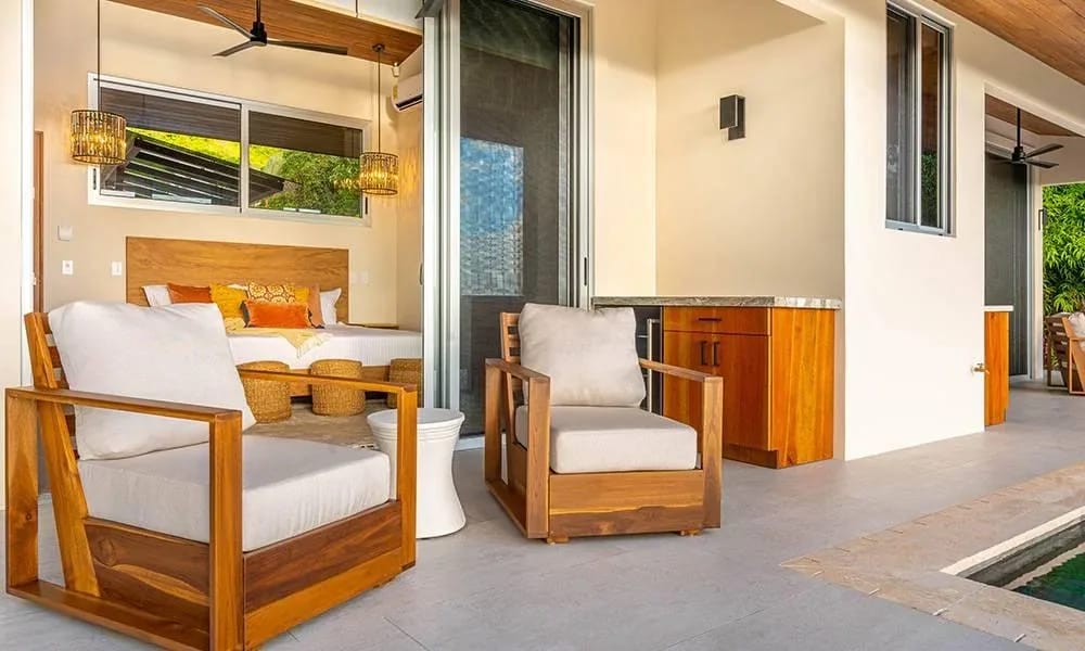Casa Grande del Mar · 5. An open-air terrace with comfortable seating and an outdoor bar connects to a king bedroom with tropical views, all steps from a refreshing pool.