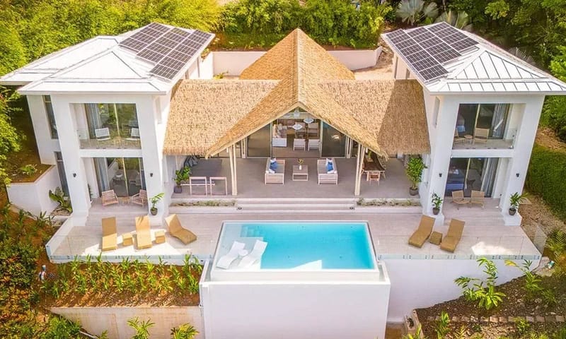 Casa Frenchie & Guest House · 6. This modern villa features white structures, a central open-air thatched living area, and an infinity pool on a spacious terrace, all set within the lush tropical jungle.